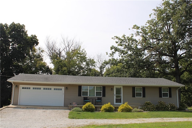 single story home with a garage and a front lawn