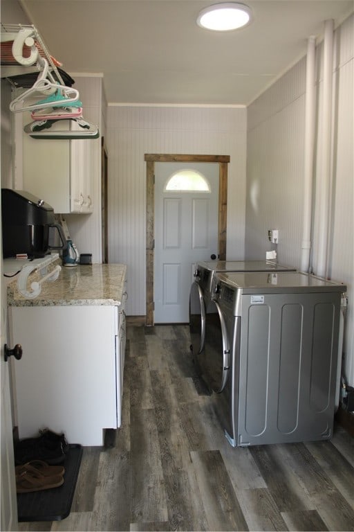 laundry area featuring cabinets, dark hardwood / wood-style flooring, and separate washer and dryer