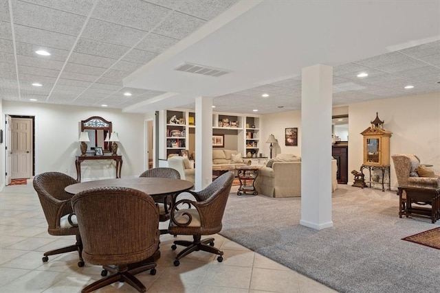 tiled dining area featuring built in shelves