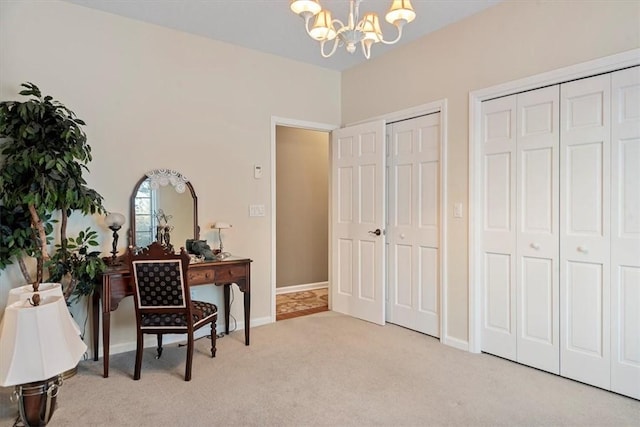 office with light carpet and an inviting chandelier