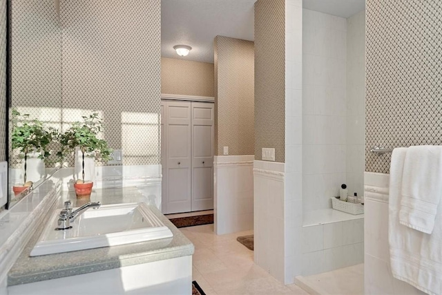 bathroom with sink and a tub to relax in