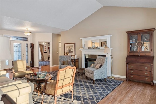 living room with vaulted ceiling and hardwood / wood-style floors