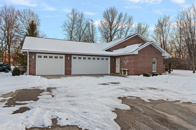 view of snowy exterior featuring a garage