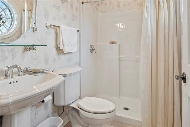 bathroom with toilet, tile patterned flooring, and curtained shower