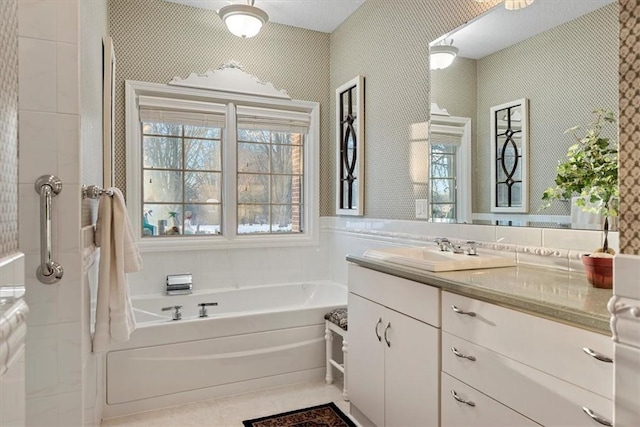 bathroom featuring tile patterned flooring, a washtub, and vanity