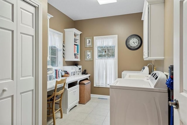 washroom with light tile patterned floors and washer and dryer