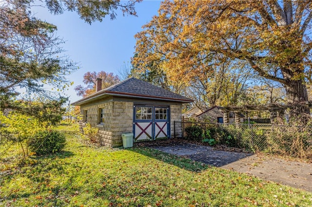 view of outbuilding with an outbuilding and fence