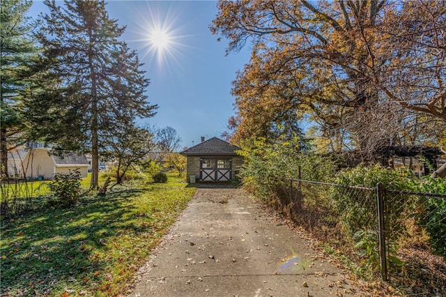 exterior space with an outbuilding, a front yard, and fence