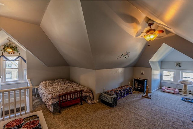 carpeted bedroom featuring vaulted ceiling, a ceiling fan, and baseboards