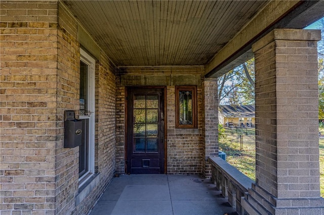 view of exterior entry with brick siding