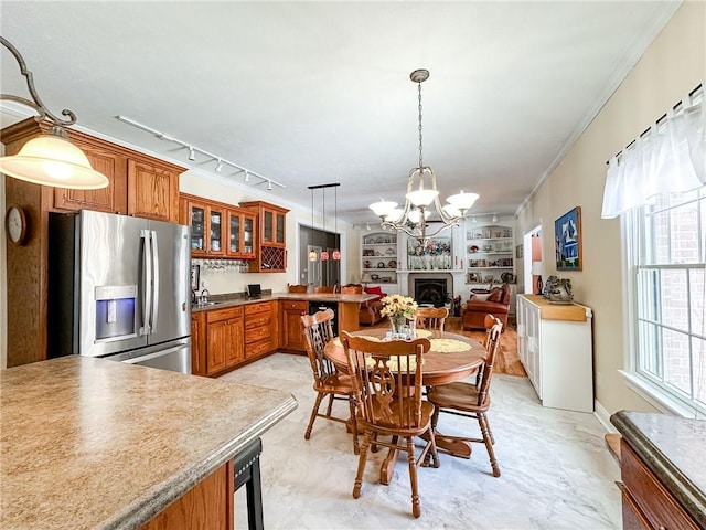 1165 Crooked Ln, Dennison, IL 62423 - dining area featuring built in shelves, ornamental molding, a chandelier, a fireplace, and rail lighting