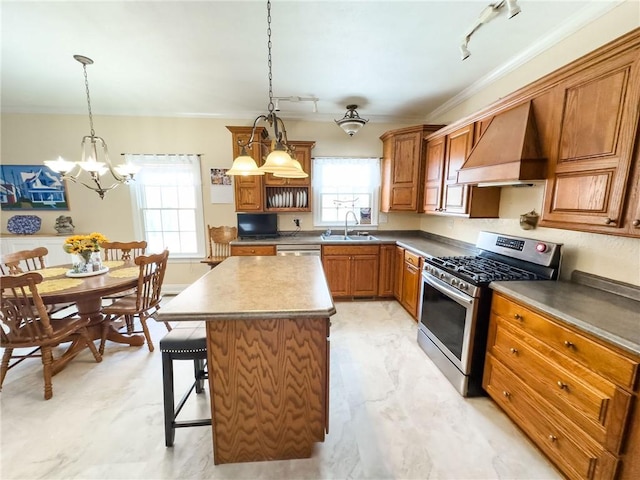 1165 Crooked Ln, Dennison, IL 62423 - kitchen with stainless steel range with gas stovetop, rail lighting, custom exhaust hood, a sink, and a notable chandelier