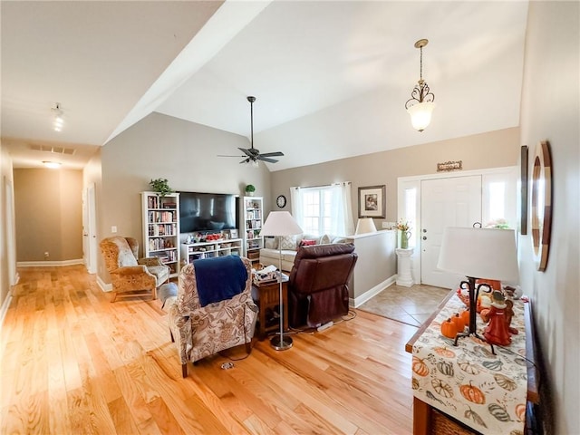 1165 Crooked Ln, Dennison, IL 62423 - living room featuring light wood-style flooring, baseboards, vaulted ceiling, and a ceiling fan