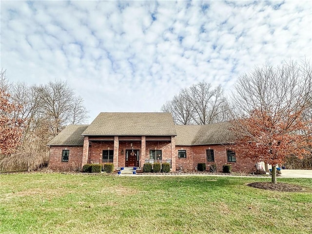 view of front of home with a porch and a front yard