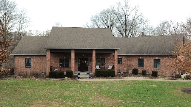 view of front of house with a porch and a front lawn