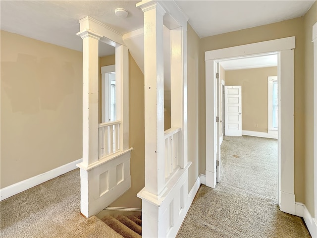 corridor featuring a wealth of natural light and carpet floors