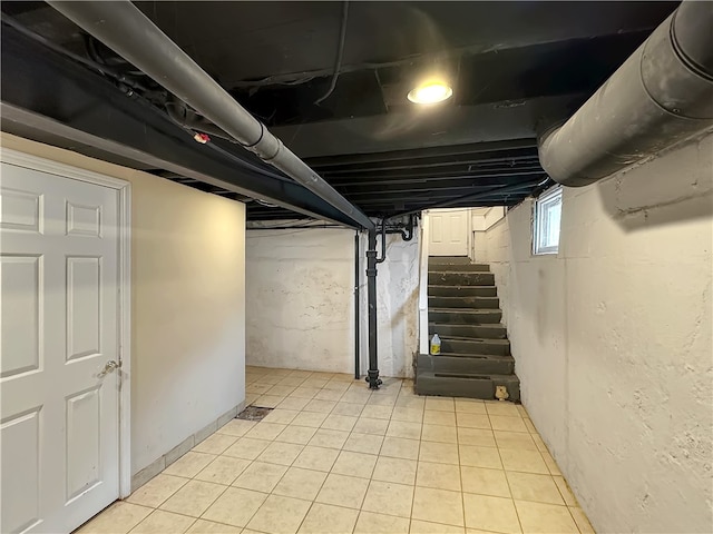 basement featuring light tile patterned flooring