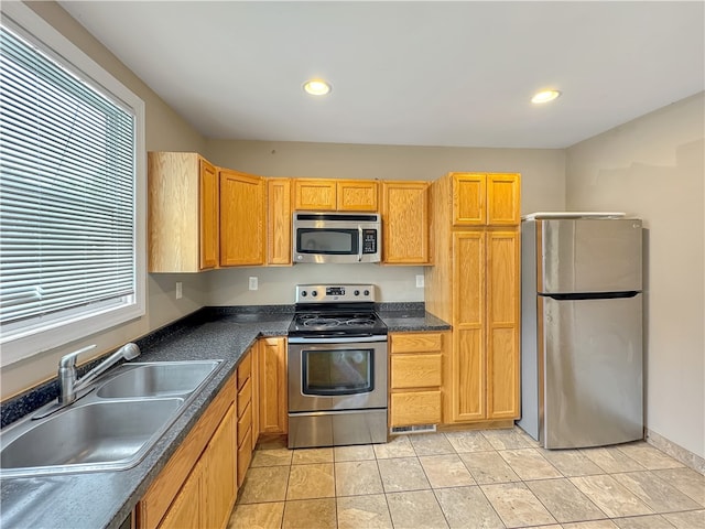 kitchen featuring light tile patterned floors, sink, and appliances with stainless steel finishes