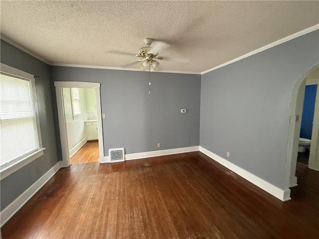 706 Douglas St, Paris, IL 61944 - unfurnished room with arched walkways, wood finished floors, a ceiling fan, a textured ceiling, and ornamental molding