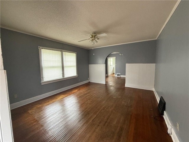 706 Douglas St, Paris, IL 61944 - empty room featuring arched walkways, ceiling fan, crown molding, dark wood-style floors, and a textured ceiling