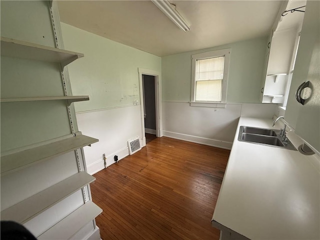 706 Douglas St, Paris, IL 61944 - kitchen featuring a sink, open shelves, dark wood-style floors, and baseboards