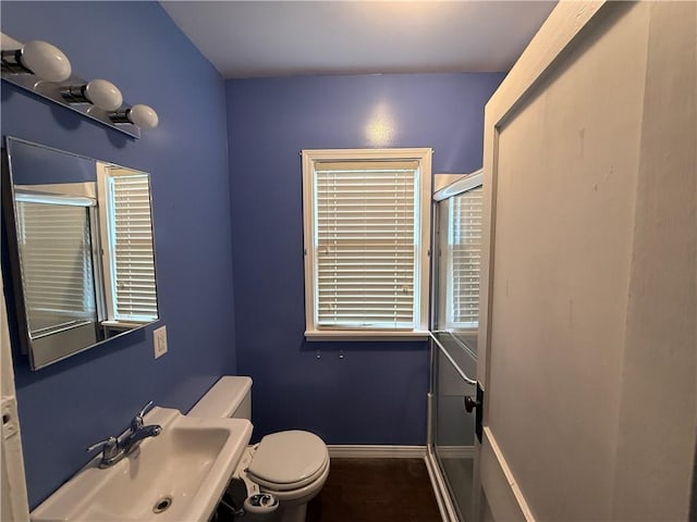 706 Douglas St, Paris, IL 61944 - bathroom with toilet, a shower stall, a sink, and baseboards