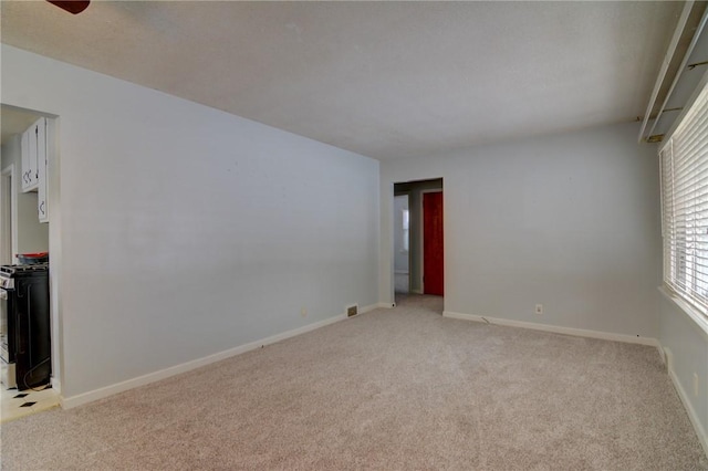 unfurnished room featuring light colored carpet