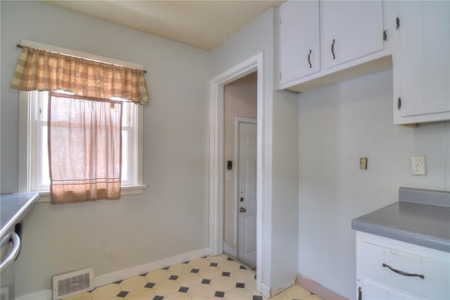 interior space with plenty of natural light and white cabinets