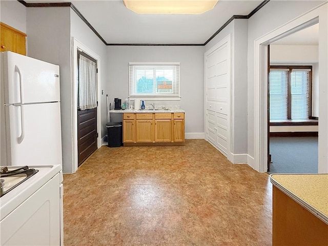 111 Andrew St, Paris, IL 61944 - kitchen featuring freestanding refrigerator, crown molding, light countertops, and range