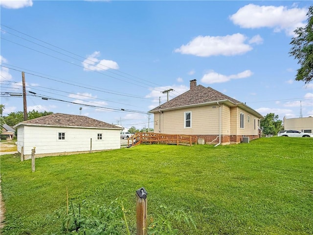 111 Andrew St, Paris, IL 61944 - back of property featuring a lawn, a chimney, and a wooden deck