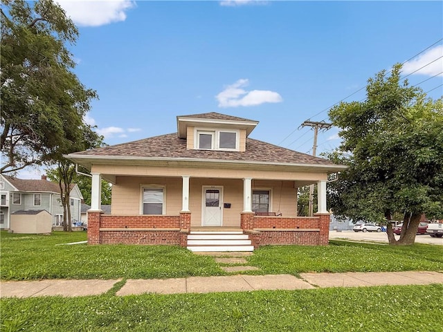 111 Andrew St, Paris, IL 61944 - bungalow-style home featuring a front lawn, a porch, and roof with shingles