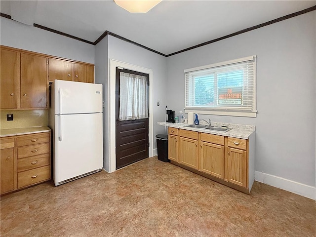 111 Andrew St, Paris, IL 61944 - kitchen featuring freestanding refrigerator, ornamental molding, light countertops, brown cabinets, and light flooring