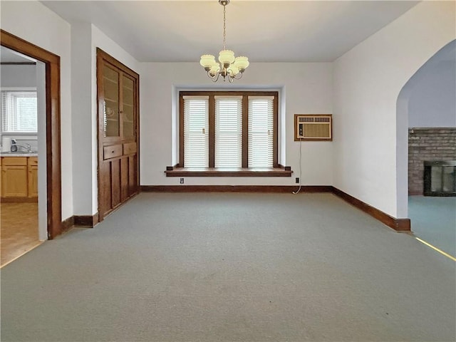 111 Andrew St, Paris, IL 61944 - unfurnished dining area with a chandelier, light colored carpet, arched walkways, and healthy amount of natural light