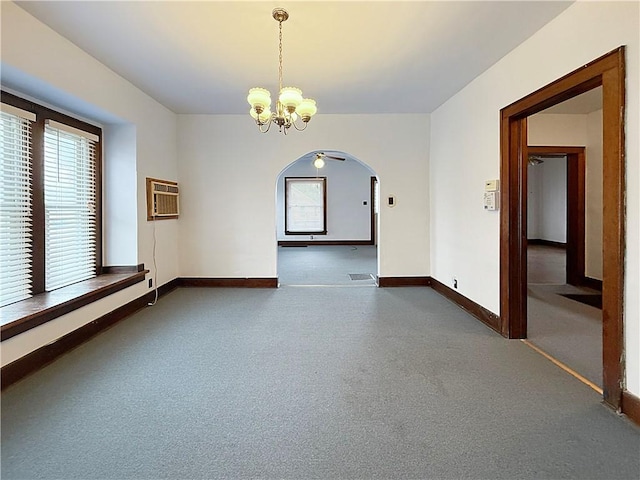 111 Andrew St, Paris, IL 61944 - spare room featuring arched walkways, a chandelier, plenty of natural light, and a wall mounted AC