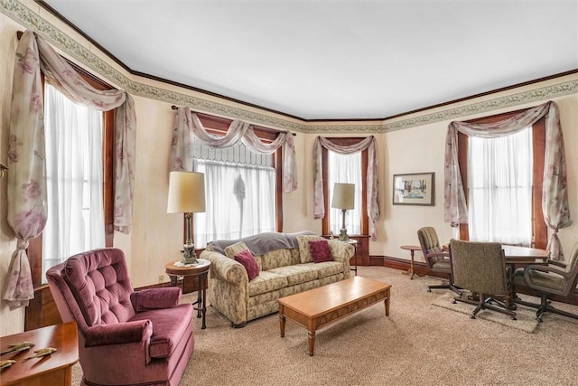 carpeted living area featuring crown molding, baseboards, and a wealth of natural light