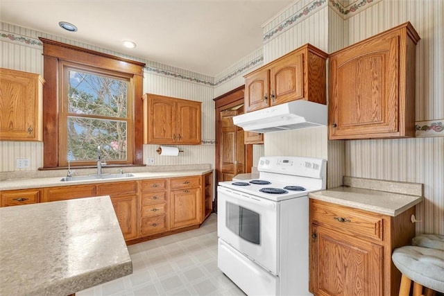 kitchen featuring wallpapered walls, electric stove, light floors, under cabinet range hood, and a sink