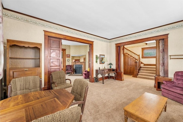 carpeted living room with crown molding, stairway, and wallpapered walls