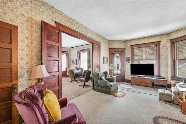 living room featuring carpet floors, wallpapered walls, and a textured ceiling