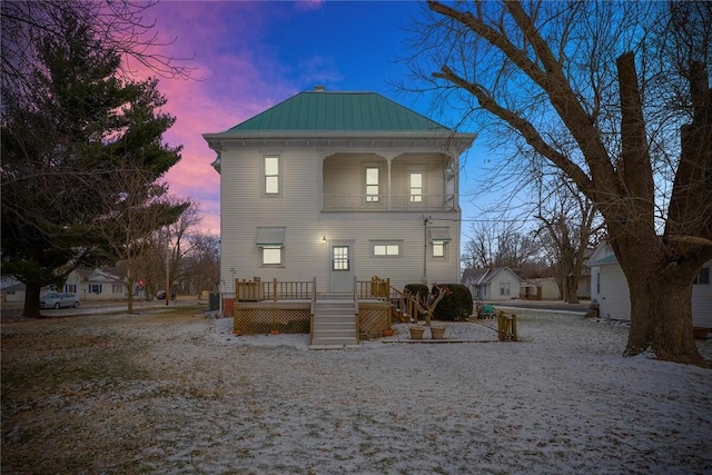 back of house featuring metal roof