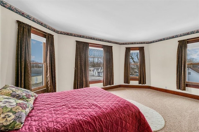 bedroom featuring carpet flooring and baseboards