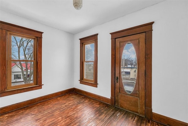 foyer featuring dark wood-style flooring and baseboards