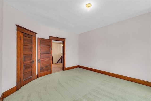 unfurnished bedroom featuring carpet flooring and baseboards