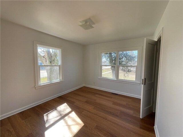 108 W Virginia Ave, Effingham, IL 62401 - spare room with dark wood-style floors, visible vents, and baseboards