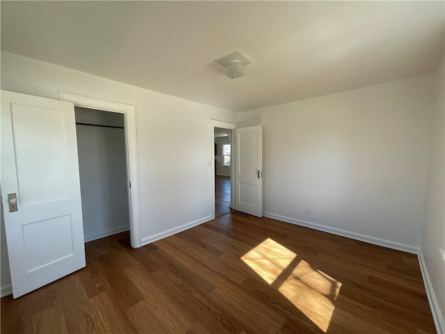 108 W Virginia Ave, Effingham, IL 62401 - unfurnished bedroom featuring a closet, wood finished floors, and baseboards