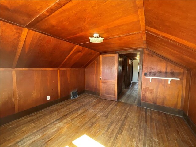 108 W Virginia Ave, Effingham, IL 62401 - bonus room with vaulted ceiling, wood-type flooring, and wooden walls