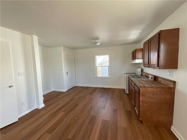 108 W Virginia Ave, Effingham, IL 62401 - kitchen with dark wood-style flooring, under cabinet range hood, baseboards, and stove