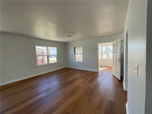 108 W Virginia Ave, Effingham, IL 62401 - spare room with dark wood-style floors, a wealth of natural light, and baseboards