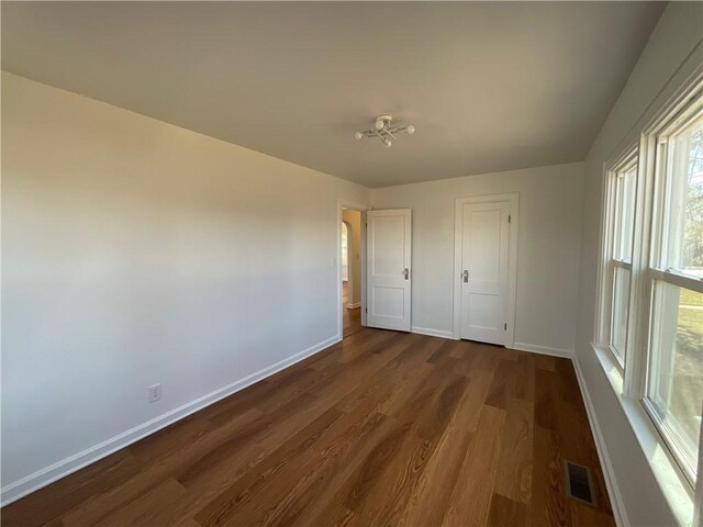 108 W Virginia Ave, Effingham, IL 62401 - unfurnished bedroom featuring baseboards, visible vents, and dark wood-type flooring