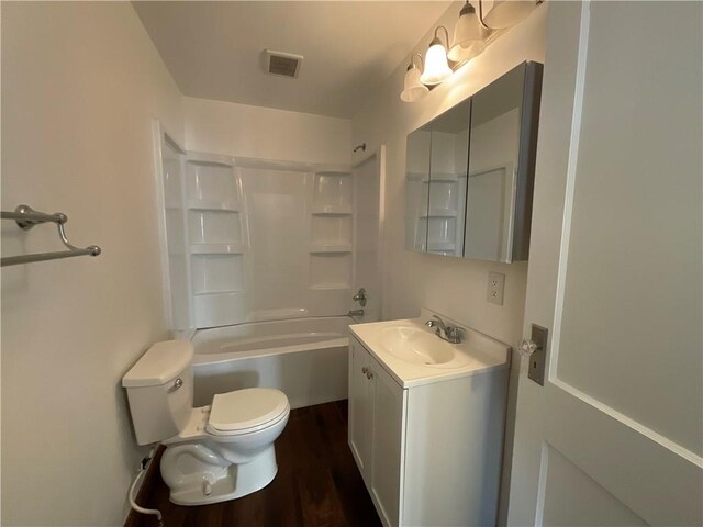108 W Virginia Ave, Effingham, IL 62401 - bathroom with visible vents, toilet, wood finished floors,  shower combination, and vanity
