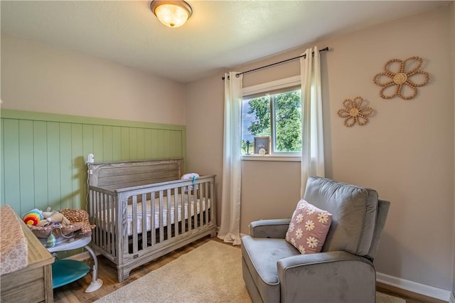 2430 Baker Ln, Decatur, IL 62526 - bedroom with wood finished floors and a nursery area